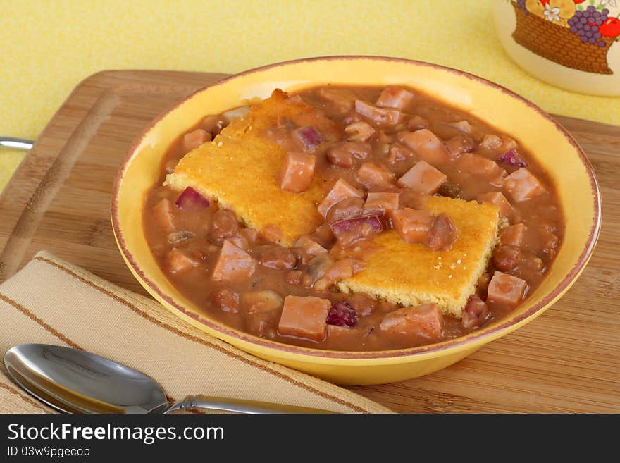 Ham and bean soup with corn bread in a bowl. Ham and bean soup with corn bread in a bowl