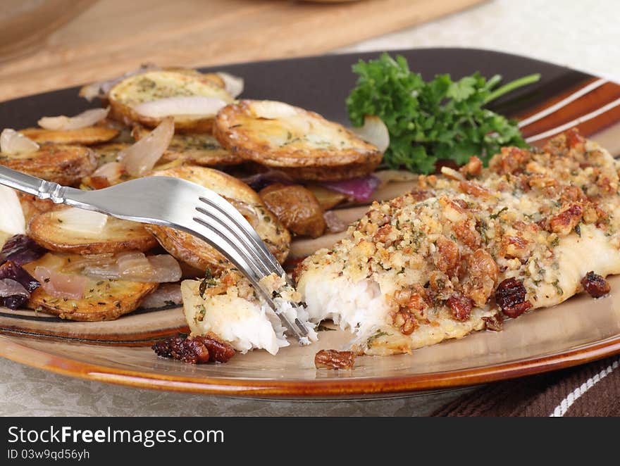 Breaded baked fish fillet with potatoes dinner. Breaded baked fish fillet with potatoes dinner