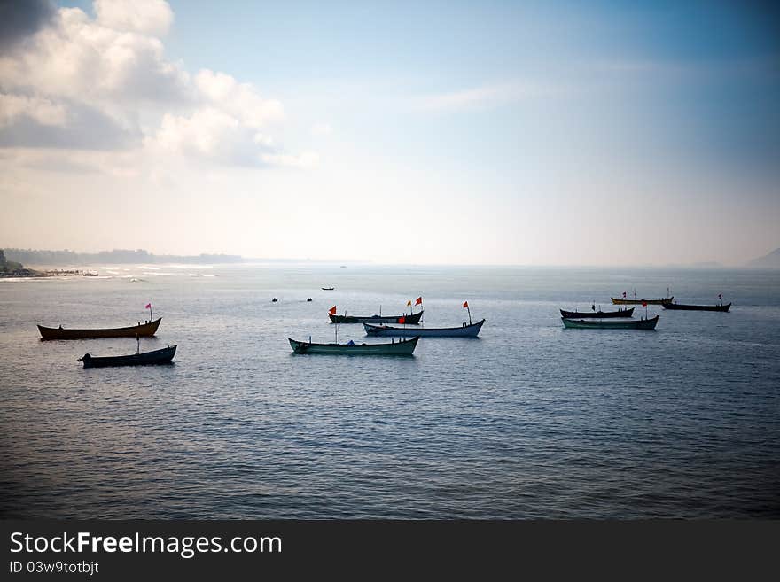 Group of small boats anchored in the blue waters of Arabian sea. murudeshwar Karnataka India. Group of small boats anchored in the blue waters of Arabian sea. murudeshwar Karnataka India