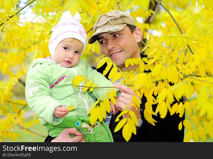 Small Beautiful Girl In Green Suit With Father