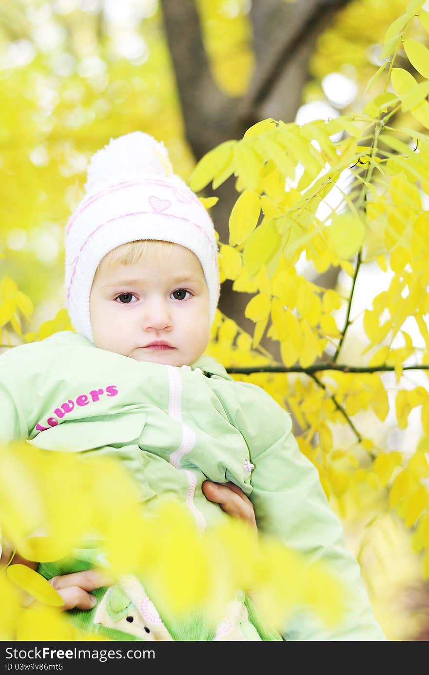 Small beautiful girl in green suit