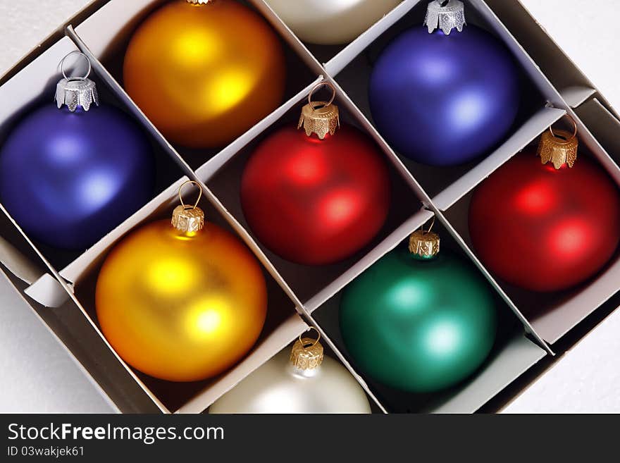 Colorful baubles in the white box. Colorful baubles in the white box