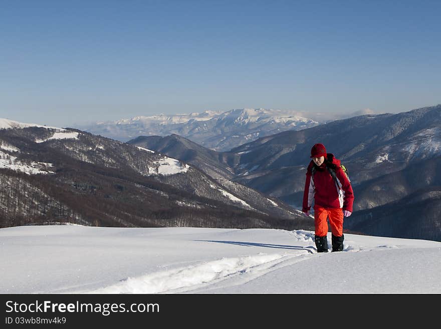 Woman climbing mountains in winter