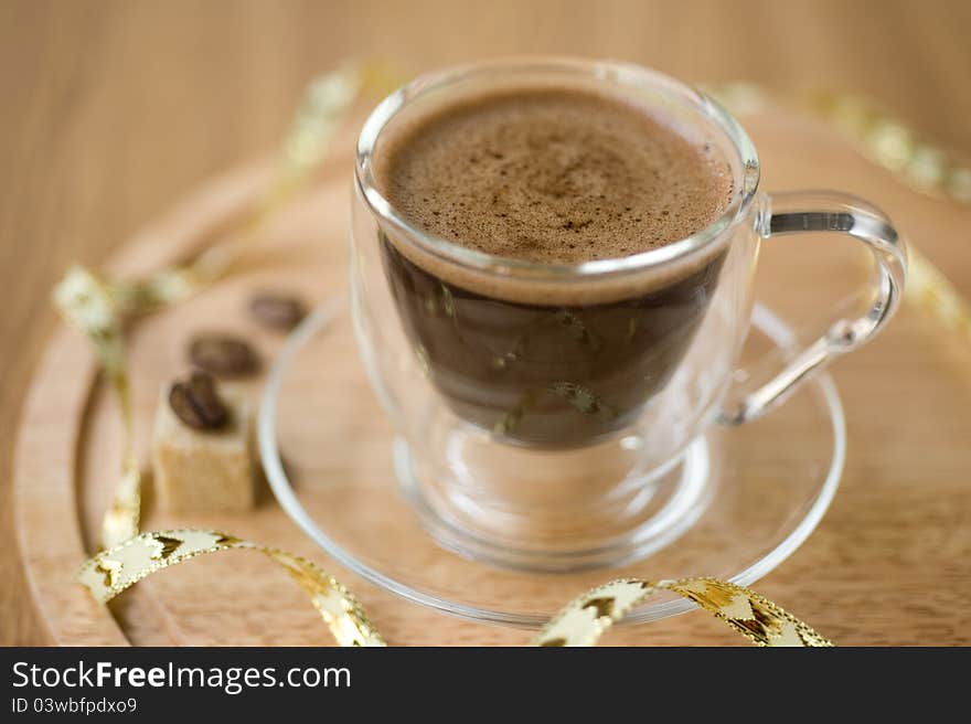 Cup of coffee, sugar, coffee beans on a wooden background