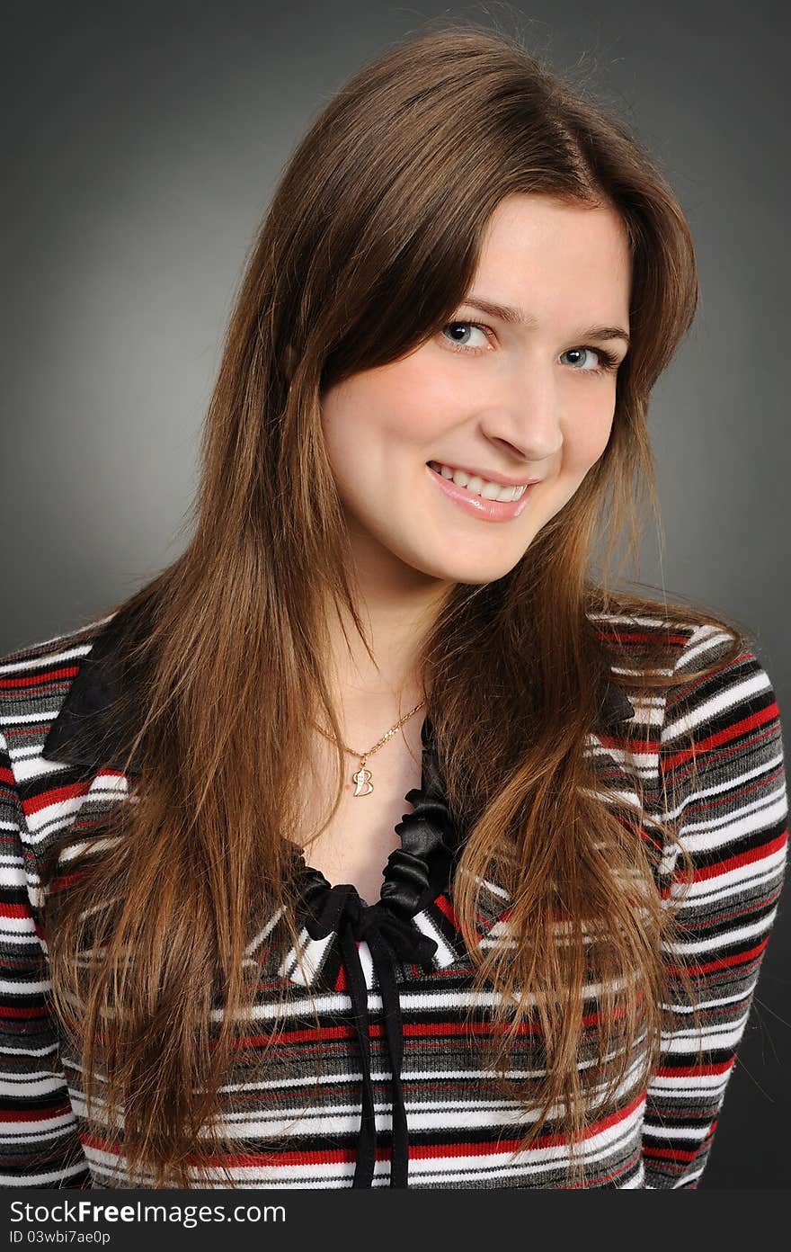 Portrait of the attractive woman on a grey background. Portrait of the attractive woman on a grey background