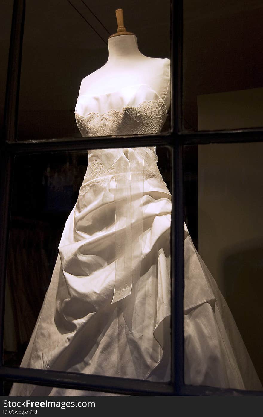 A beautiful traditional wedding dress in shop display.