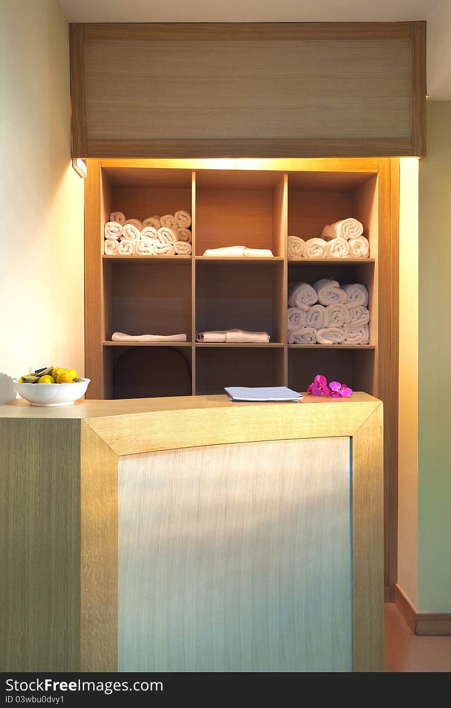 Part of a fitness center, white towels on shelves.