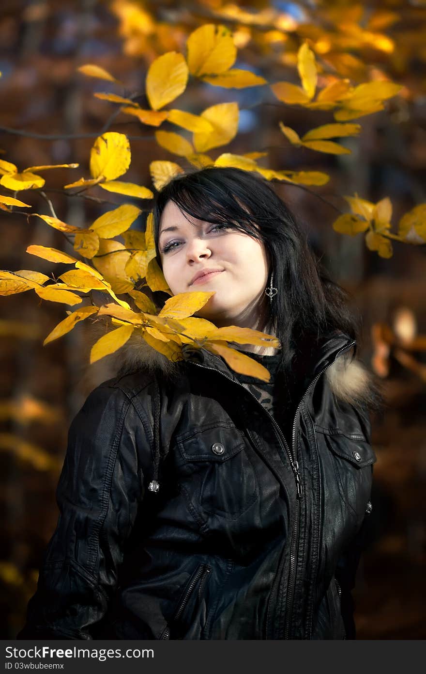 Happy young woman in autumn forest