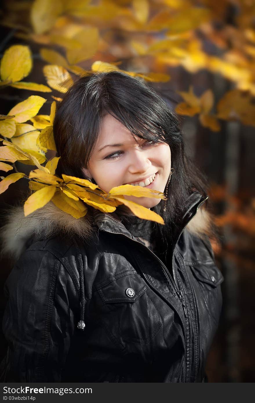 Happy young woman in autumn forest