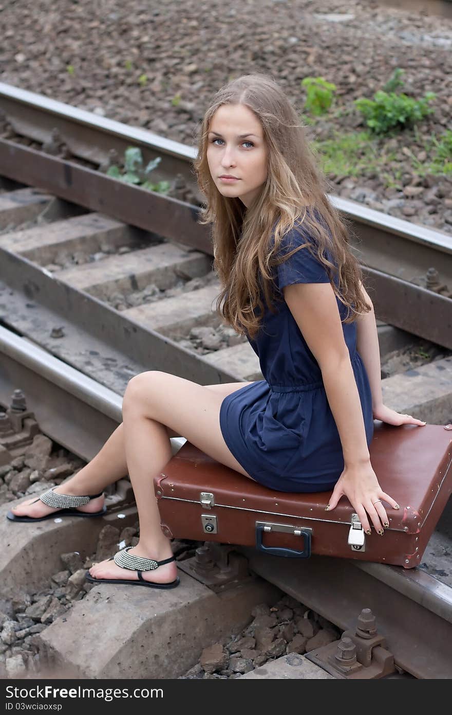 Woman sitting on rails outdoors shooting