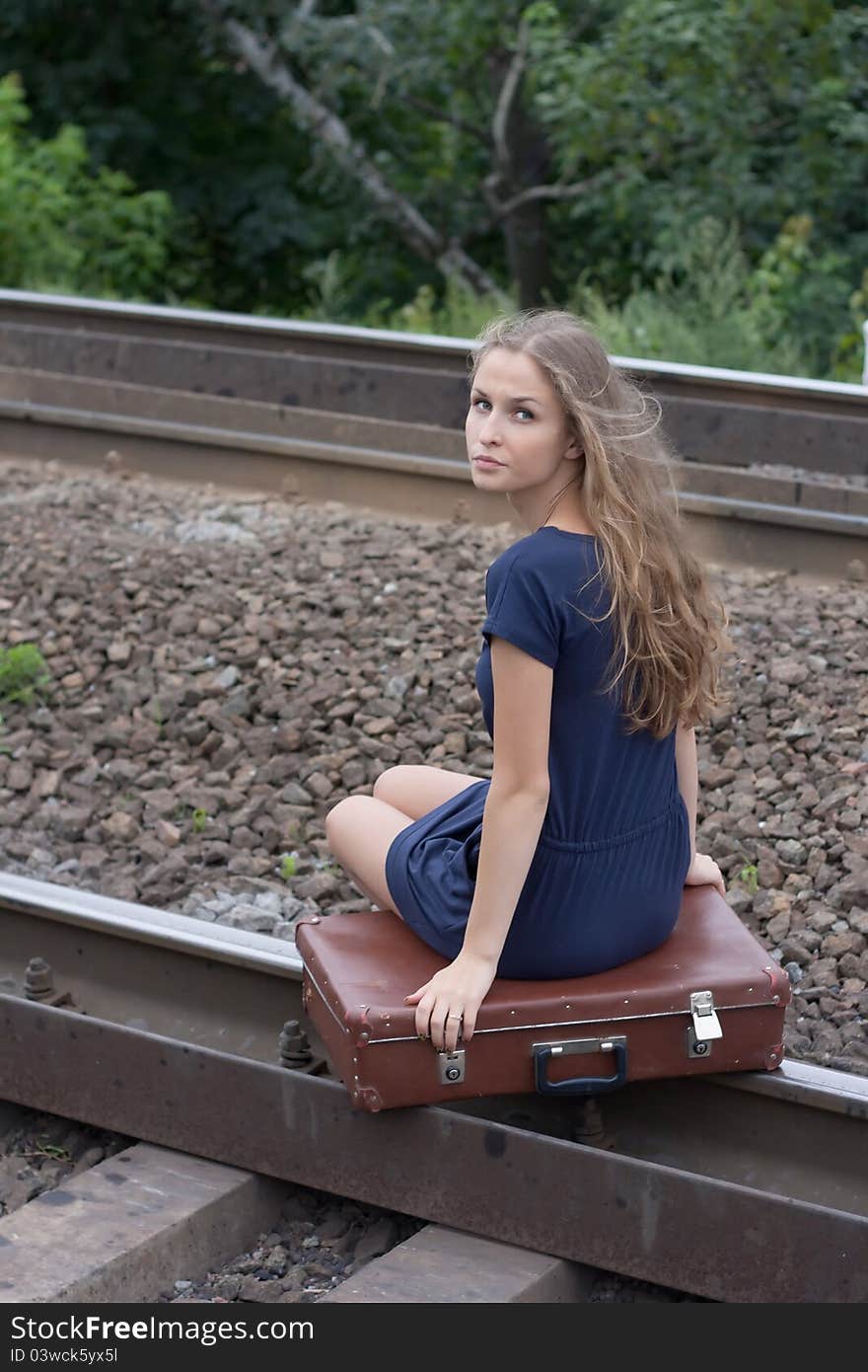 Woman sitting on rails outdoors shooting