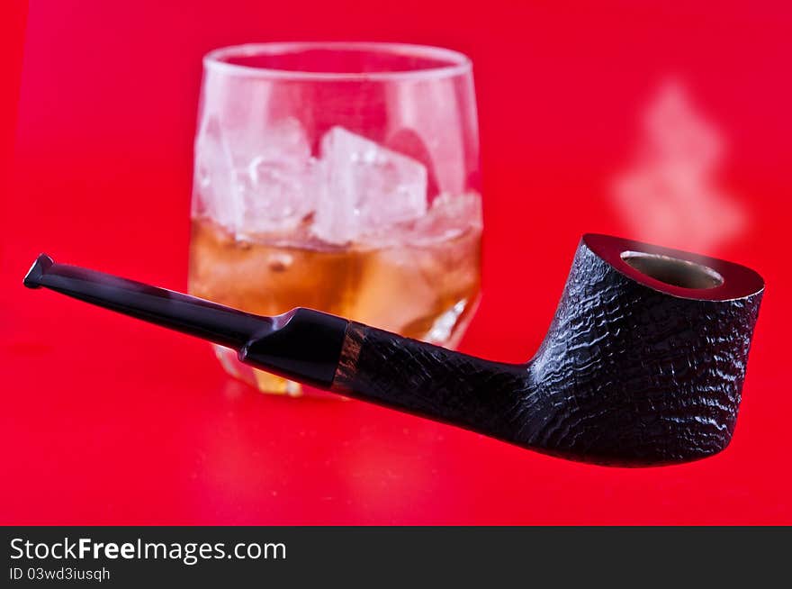 Pipe and whiskey with ice