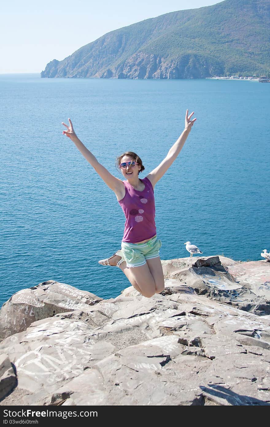 Girl jumping on the background of the sea outdoors shooting