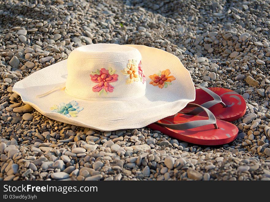 Hat and flip-flops on the stones outdoors shooting