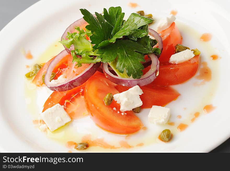 Tomato, onion and feta cheese salad with vinaigrette. Tomato, onion and feta cheese salad with vinaigrette