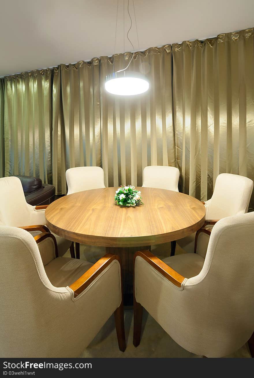 A part of a hotel interior, table and armchairs all around. A part of a hotel interior, table and armchairs all around.