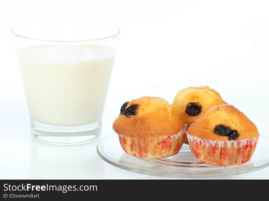 Muffin raisin and milk on white background