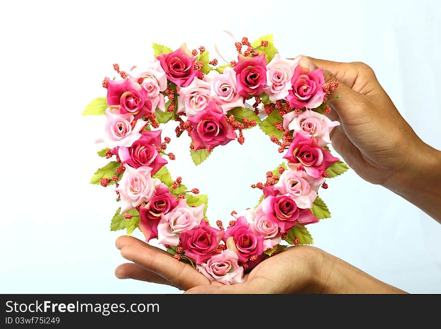 Heart rose invents of hand on white background