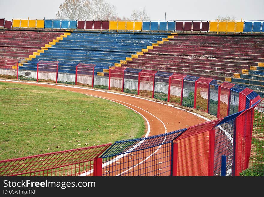 Red blue football stadium and metallic fence