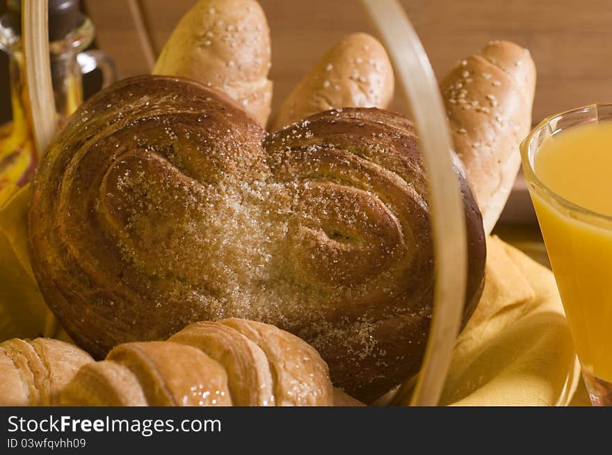 Sweet bread food in a basket over wood background