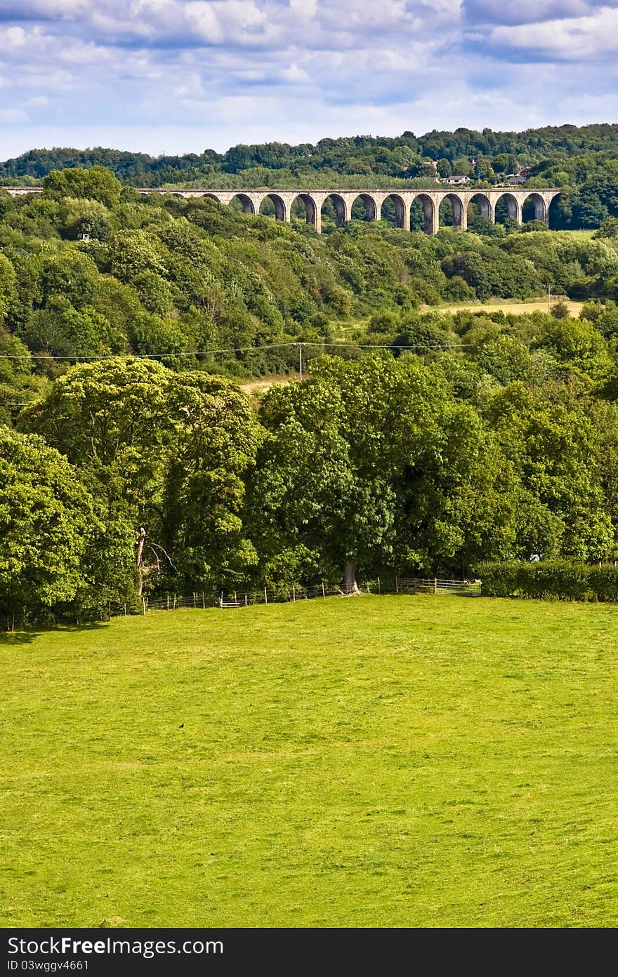 Stone viaduct crossing a welsh valley surrounded by trees and fields. Stone viaduct crossing a welsh valley surrounded by trees and fields