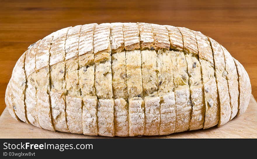 Close up of a loaf of pre-sliced olive and herb bread. Close up of a loaf of pre-sliced olive and herb bread.