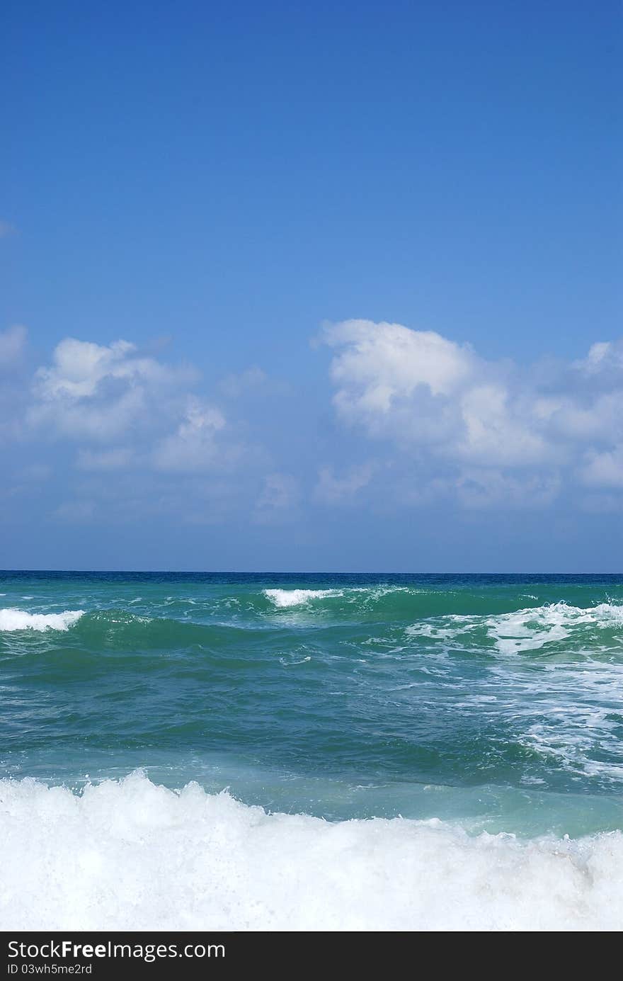 Running waves under the blue sky. Mediterranean sea.