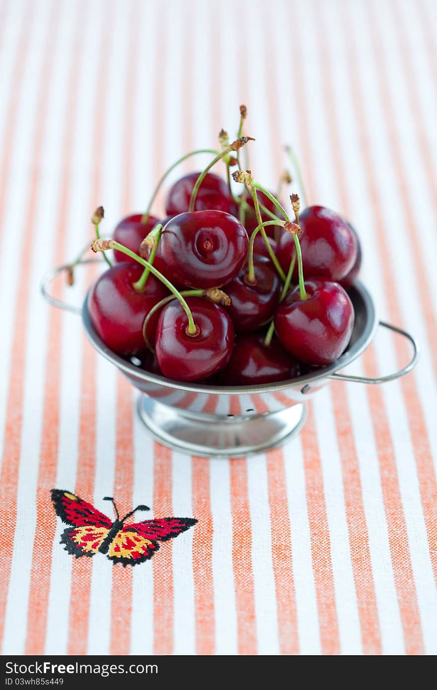 Fresh Cherries In Metal Colander