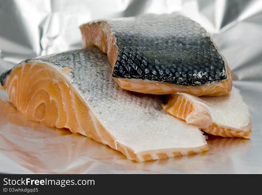 Pieces of salmon on aluminum foil