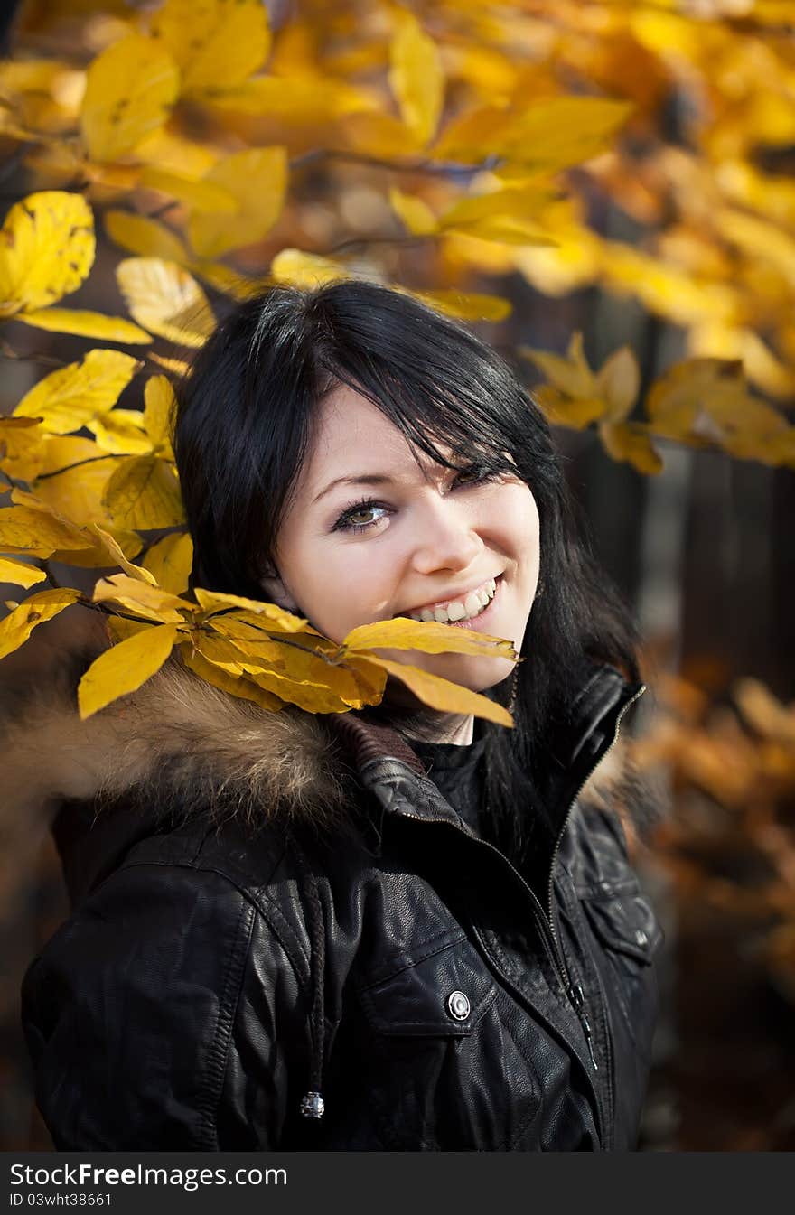 Happy young woman in autumn forest