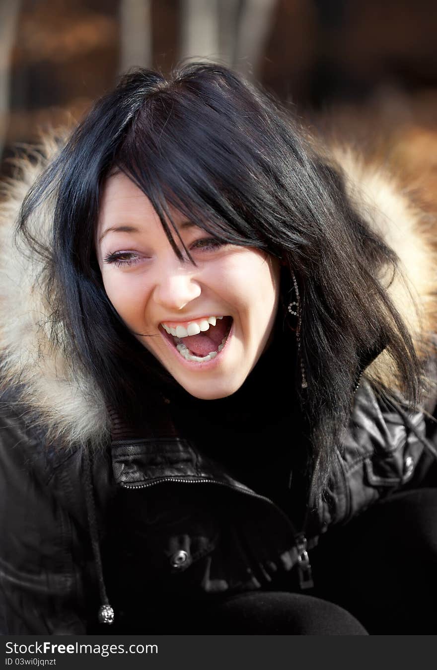 Young woman in a leather jacket smiling. Young woman in a leather jacket smiling