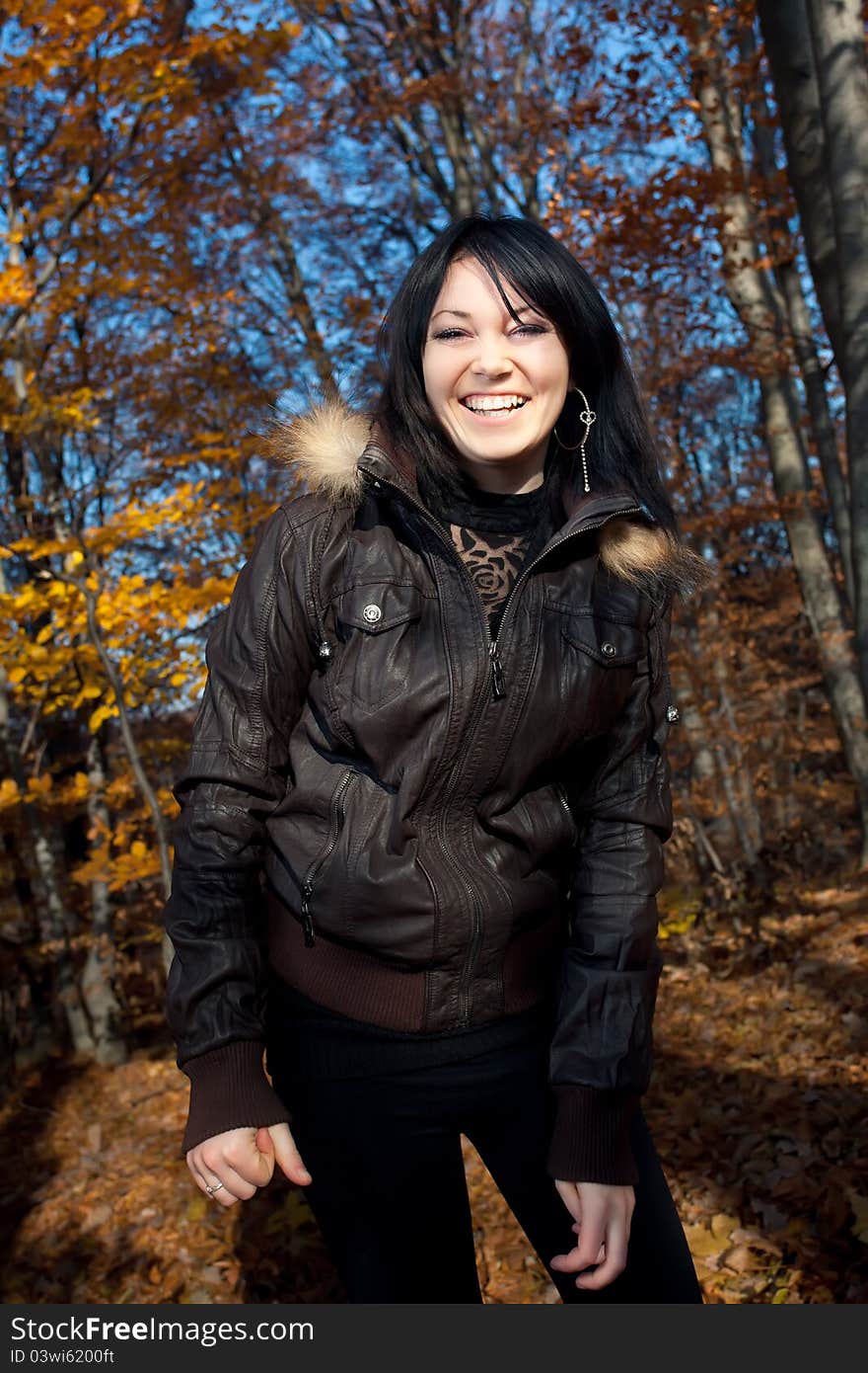 Smiling young woman in autumn forest. Smiling young woman in autumn forest