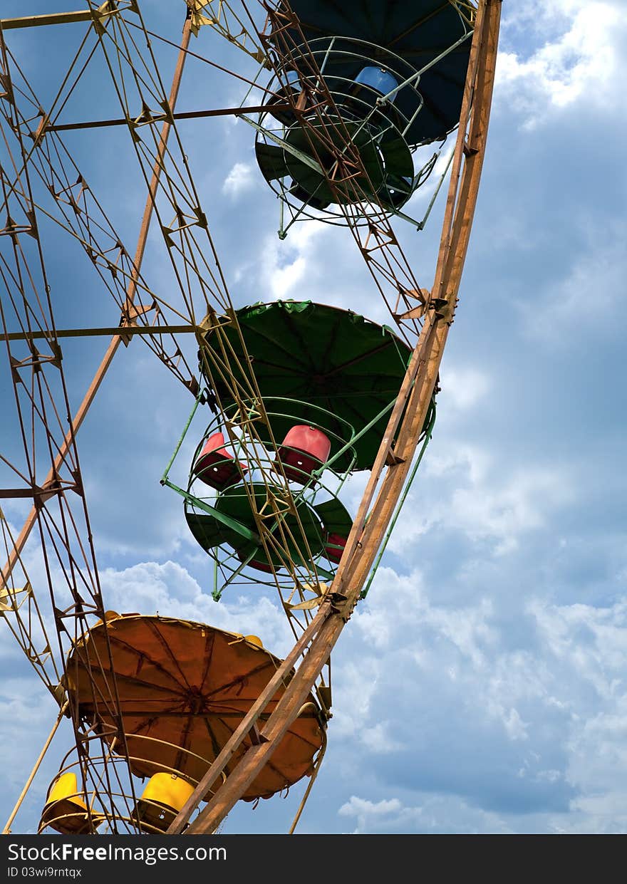 Ferris wheel agains blue skies and clouds