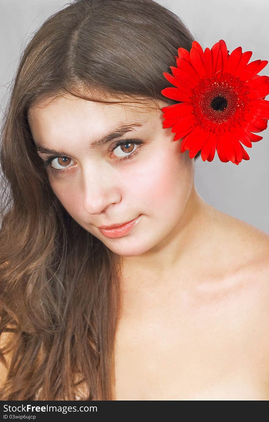 Portrait of smiling young woman with flower