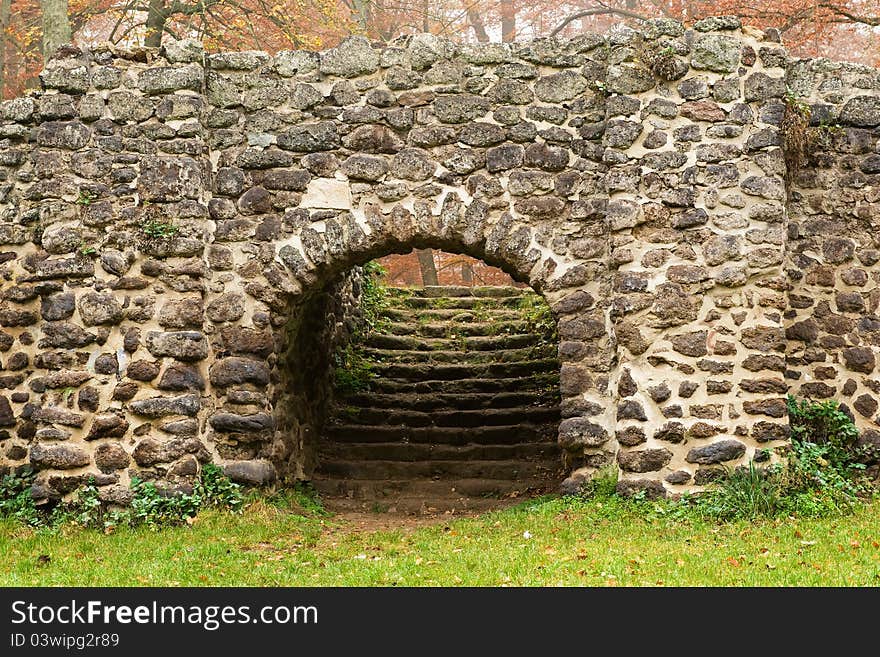 Medieval stone wall in autumn park