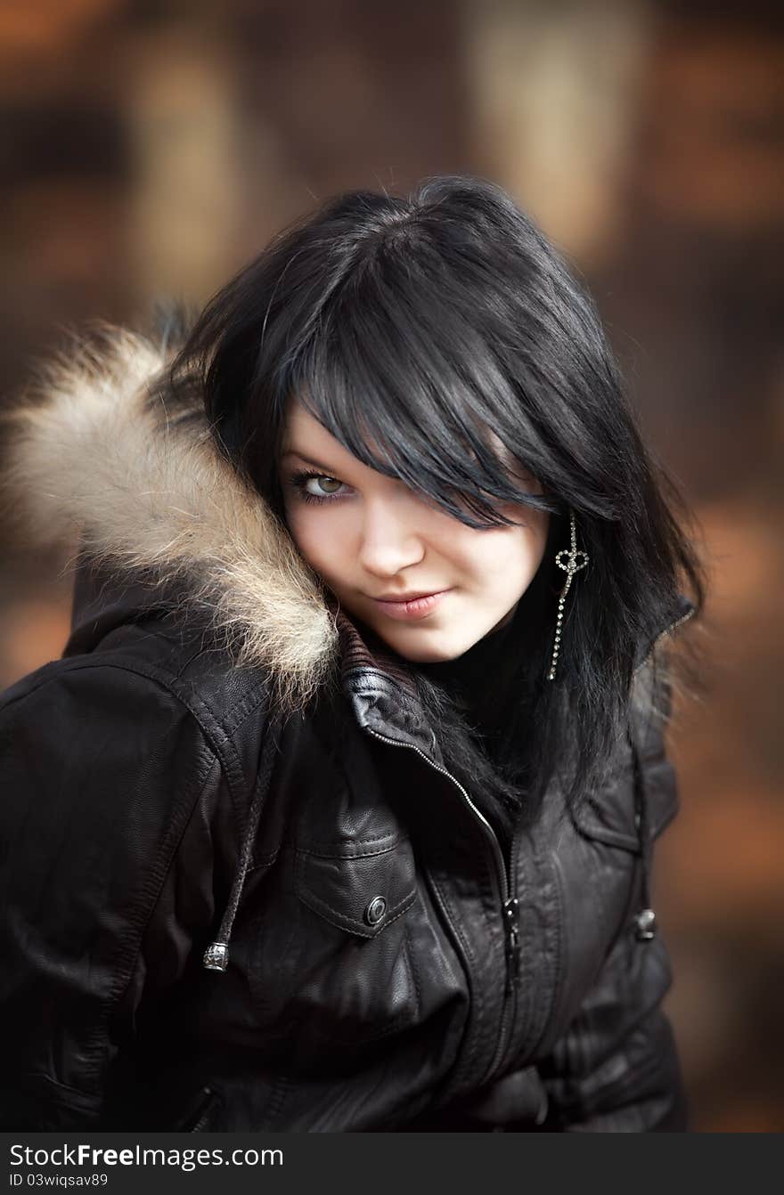 Young woman in a leather jacket looking with interest. Young woman in a leather jacket looking with interest