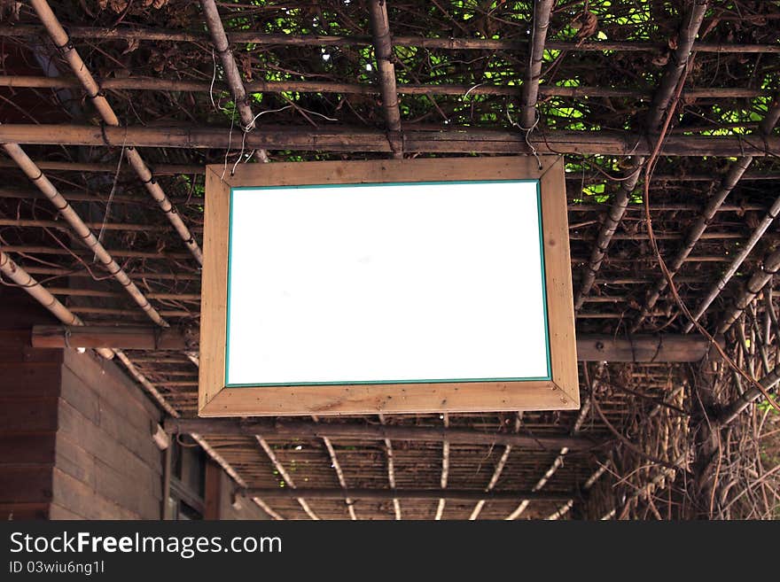 A blank white board hanging on the bamboo support. A blank white board hanging on the bamboo support.