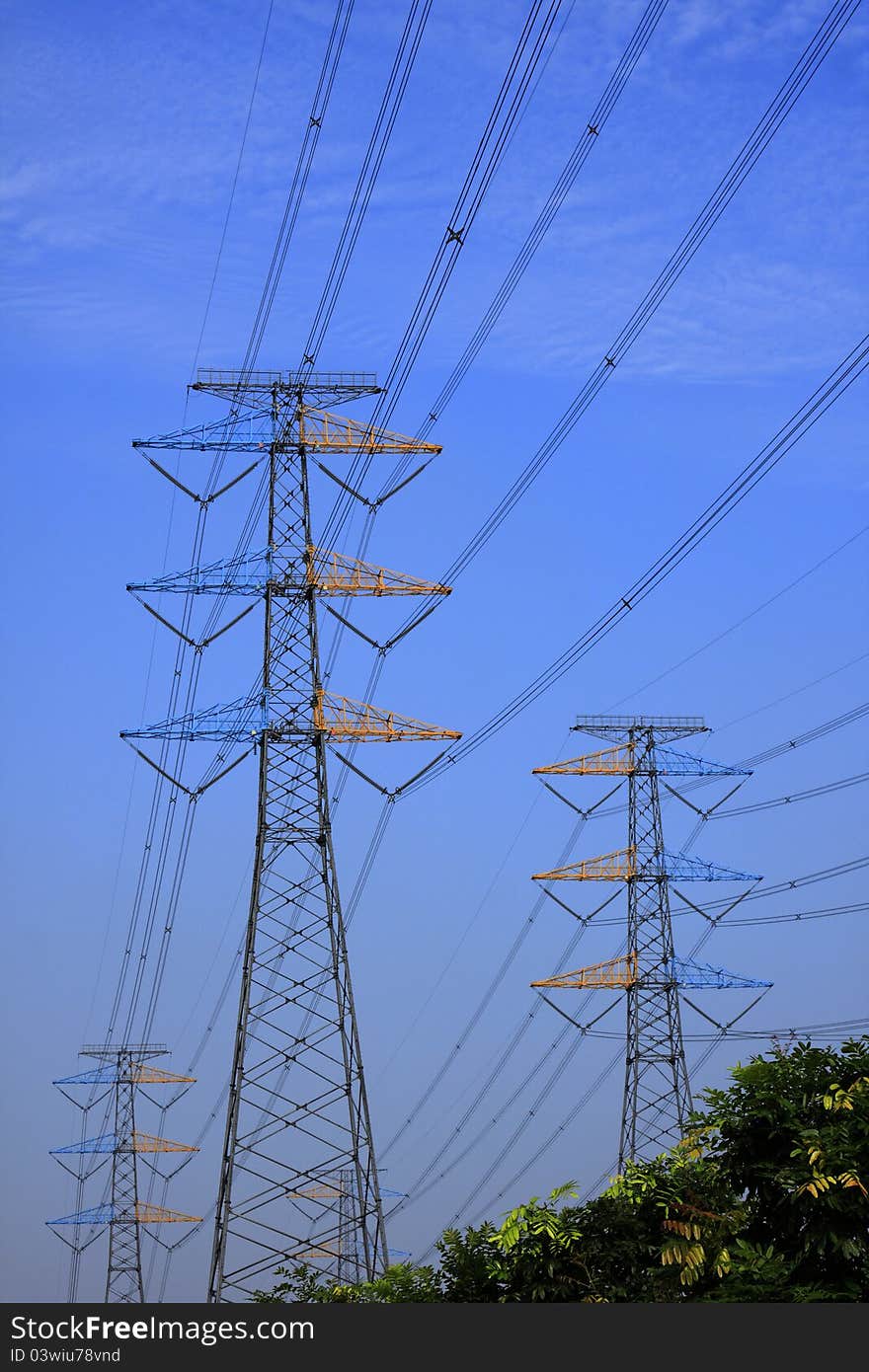 Power line on steel tower against blue sky