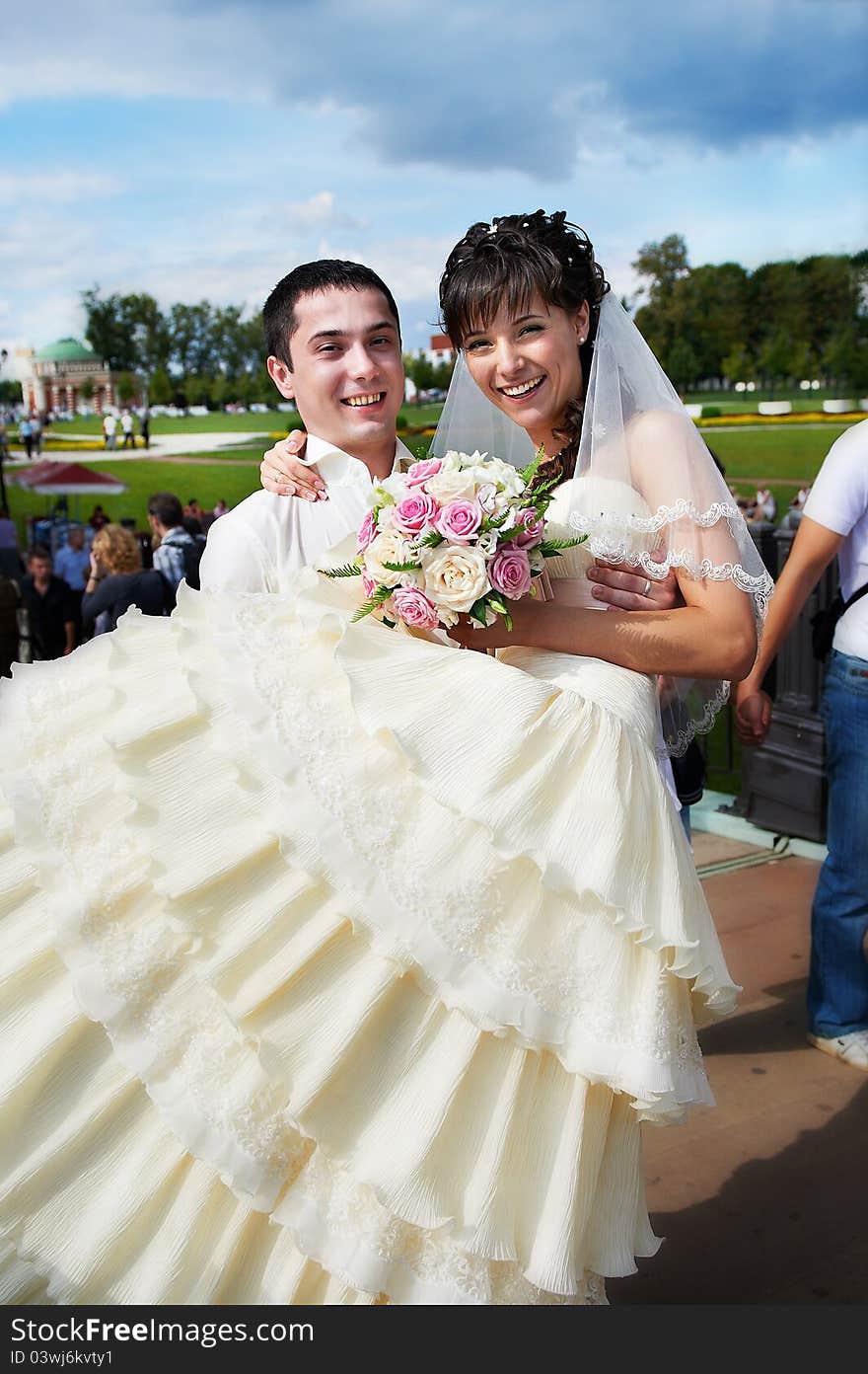 Groom carries his bride in arms