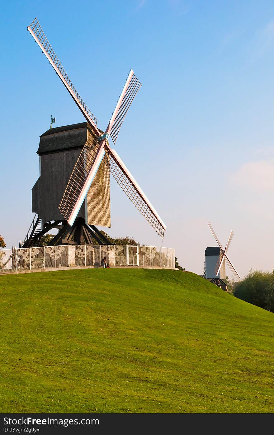 View of two old wind mill and green lawn at Brugge - Belgium. View of two old wind mill and green lawn at Brugge - Belgium