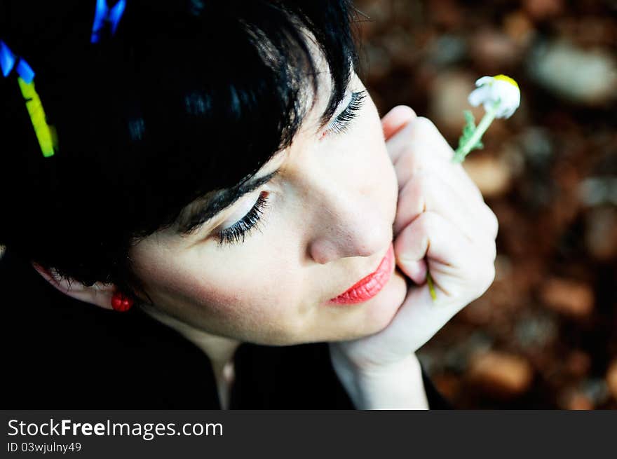 Portrait of a pretty brunette woman with clothespins on her hair thinking in the field. Portrait of a pretty brunette woman with clothespins on her hair thinking in the field