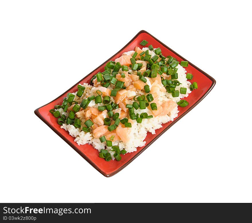 Delicious appetizing white boiled rice garnished with tasty sliced salmon and decorated with finely chopped green leek in rectangular black and red chinese dish isolated on white background. Delicious appetizing white boiled rice garnished with tasty sliced salmon and decorated with finely chopped green leek in rectangular black and red chinese dish isolated on white background