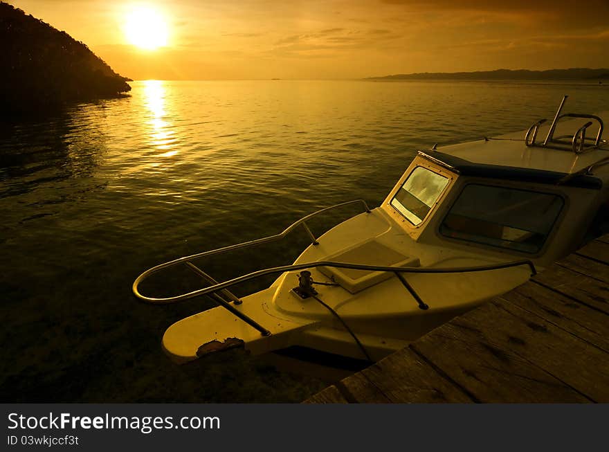 A common speedboat for diving and fishing, illuminated with sunset light. Picture taken from Raja Ampat island, papua, indonesia. A common speedboat for diving and fishing, illuminated with sunset light. Picture taken from Raja Ampat island, papua, indonesia.