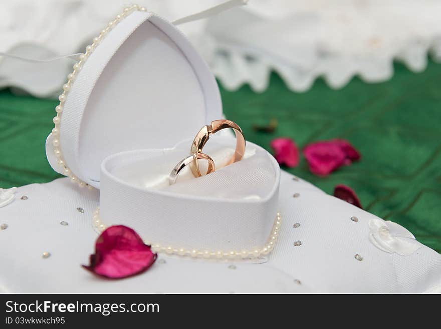 Golden wedding rings in a white box