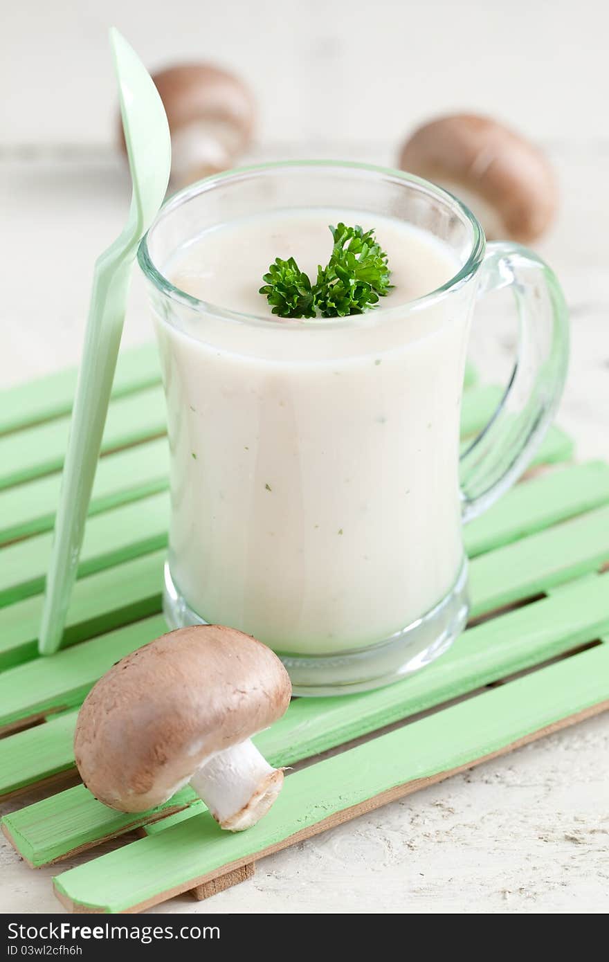 Fresh mushroom soup in a cup with parsley