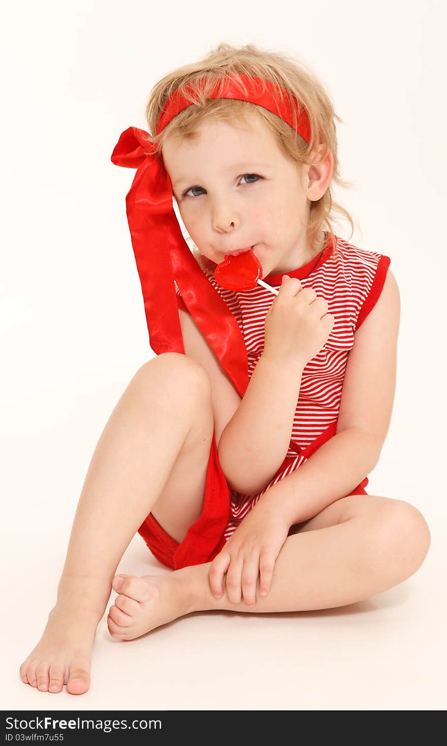 Little girl in a red dress with sweet heart. Little girl in a red dress with sweet heart.