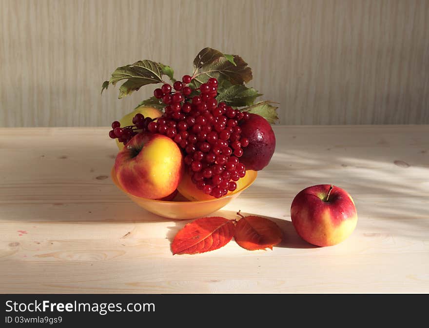 Apples and cranberry high berries in a plate on desktop. Apples and cranberry high berries in a plate on desktop.