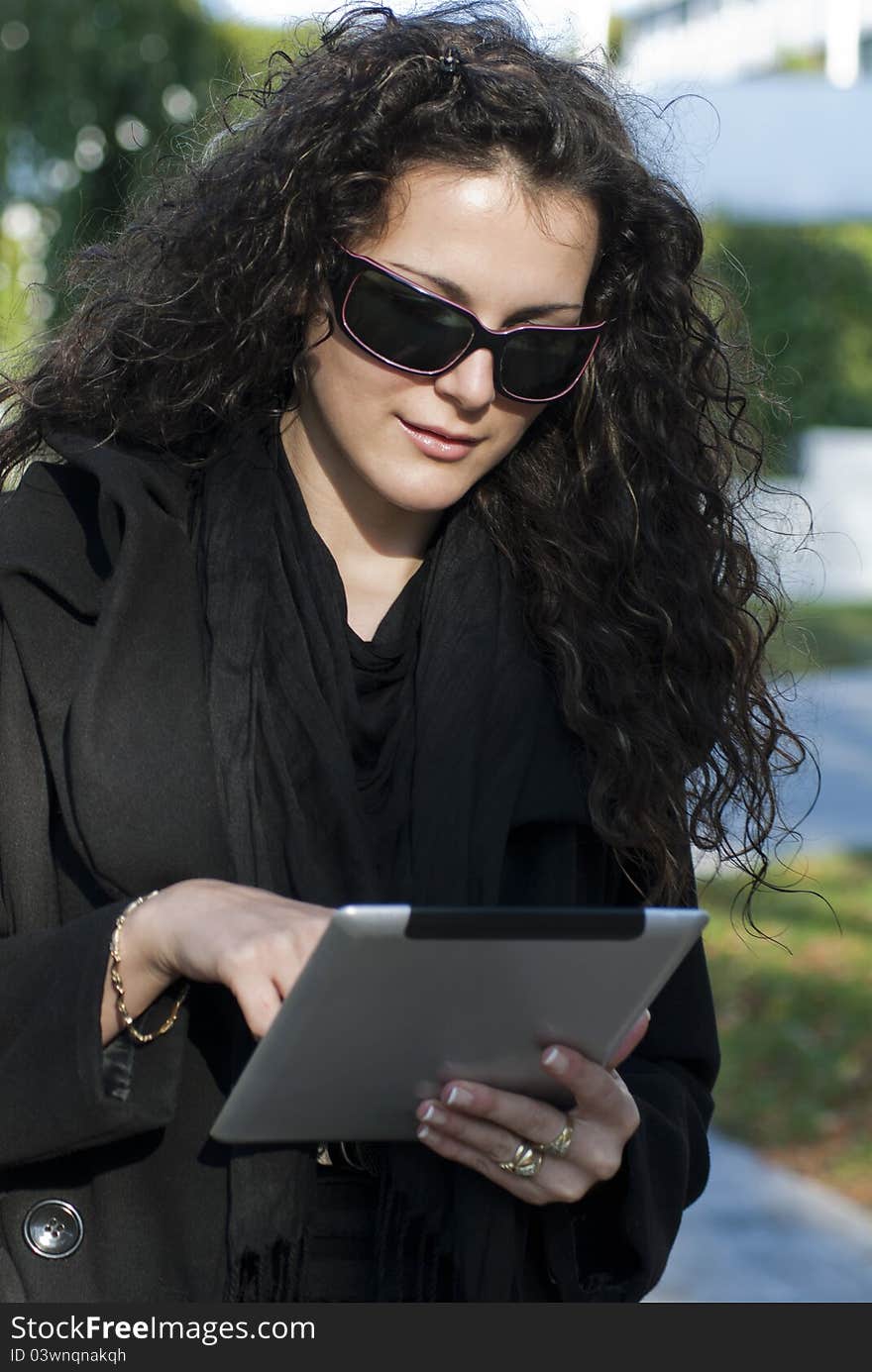 Young woman and  tablet pc in the park