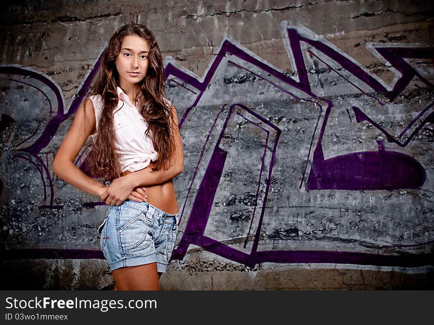 Happy young model next to concrete.