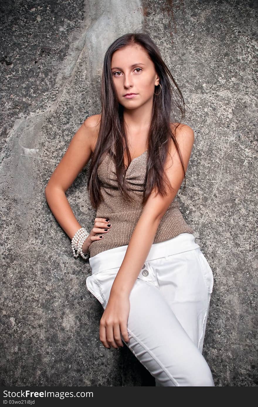 Happy young model next to concrete.